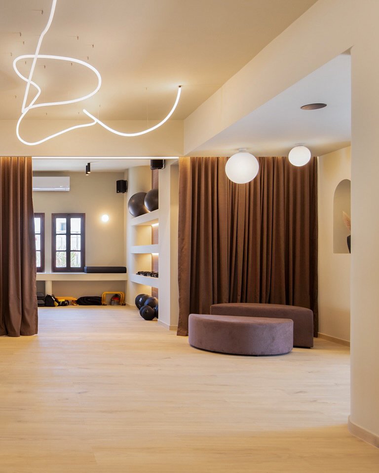 fitness architecture,sifnos gym design,boutique gym interior,cycladic architecture,commercial fitness space,natural materials design,organic lighting design,gym under construction,fitness club 2025,greek island architecture,earth tone interior,curved forms design,led ceiling feature,serene gym design,modern cycladic style,Sifnos,Commercial
